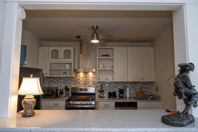 kitchen with tasteful backsplash, white cabinets, appliances with stainless steel finishes, wall chimney range hood, and open shelves