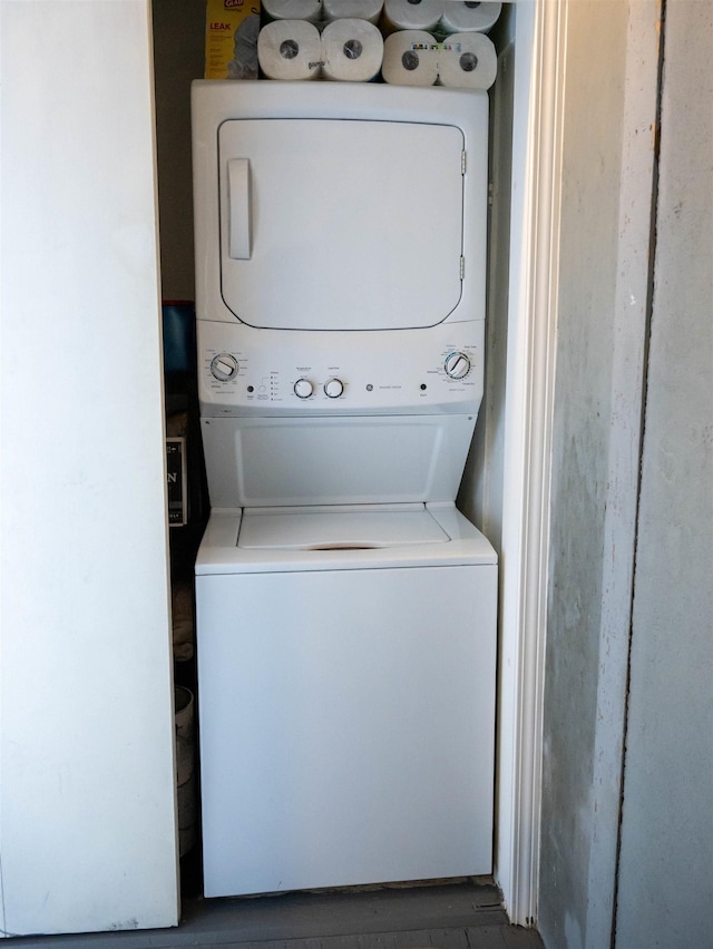 laundry area with stacked washer / dryer