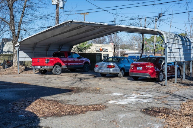 view of car parking with aphalt driveway and a carport