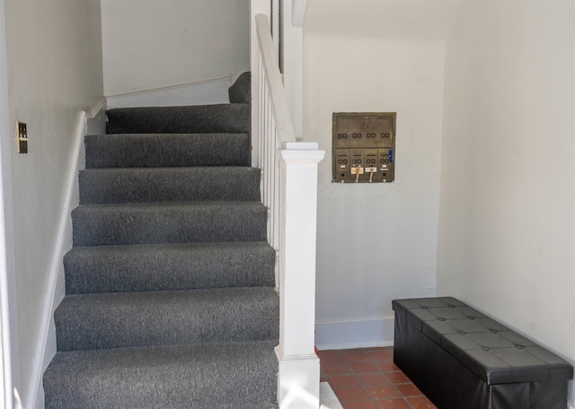 stairway with tile patterned floors