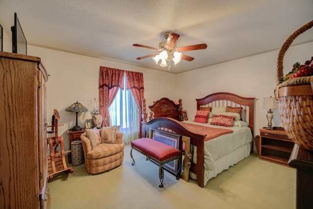 carpeted bedroom with a textured ceiling and a ceiling fan