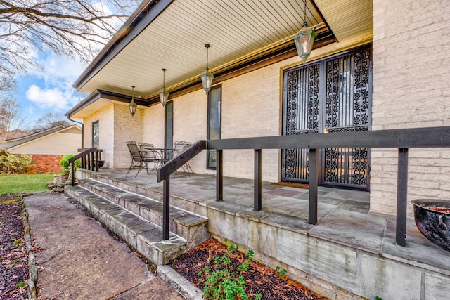 doorway to property with brick siding