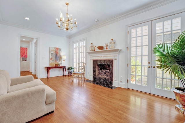 living room featuring ornamental molding, wood finished floors, and french doors