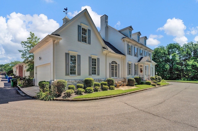 view of front of property featuring a garage and driveway