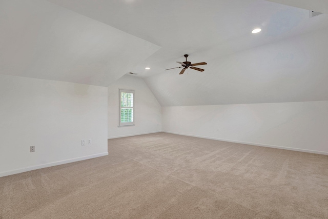 additional living space with lofted ceiling, recessed lighting, baseboards, and light colored carpet