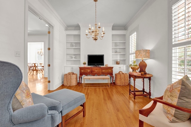 living area with light wood finished floors, baseboards, an inviting chandelier, crown molding, and built in shelves