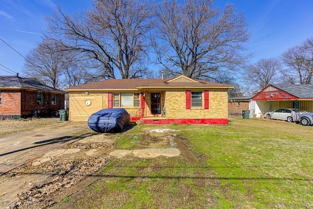 view of front of property with brick siding, crawl space, and a front yard