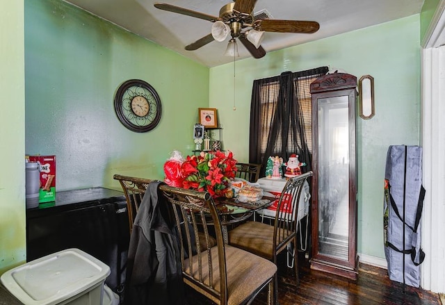 dining space featuring ceiling fan and dark wood-type flooring