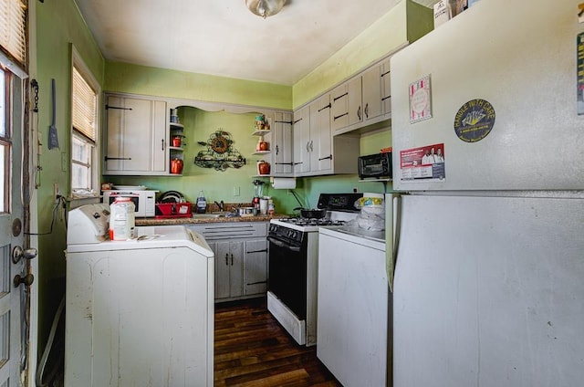 kitchen featuring white appliances, dark wood-style flooring, a sink, open shelves, and washer / dryer