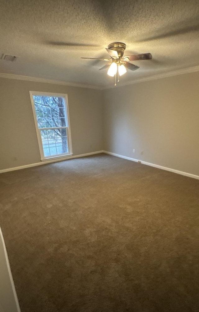 unfurnished room featuring baseboards, ceiling fan, ornamental molding, dark colored carpet, and a textured ceiling