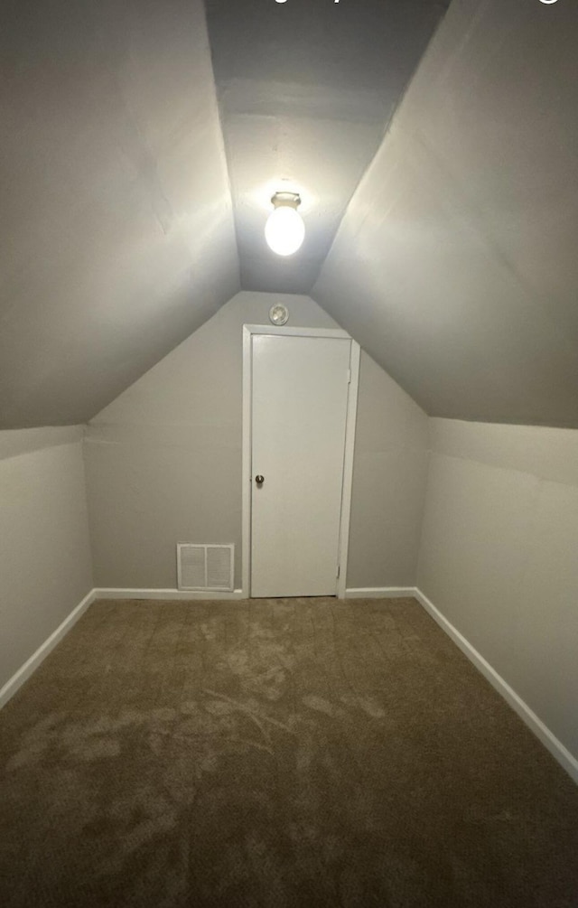 bonus room with carpet floors, lofted ceiling, visible vents, and baseboards