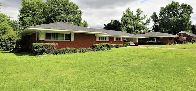 single story home featuring a front lawn and brick siding