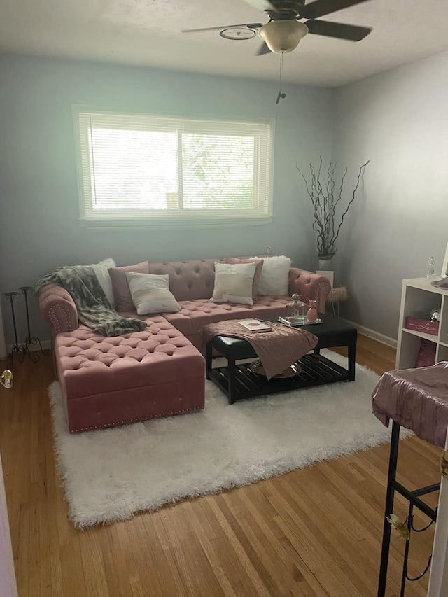 living room with ceiling fan and wood finished floors