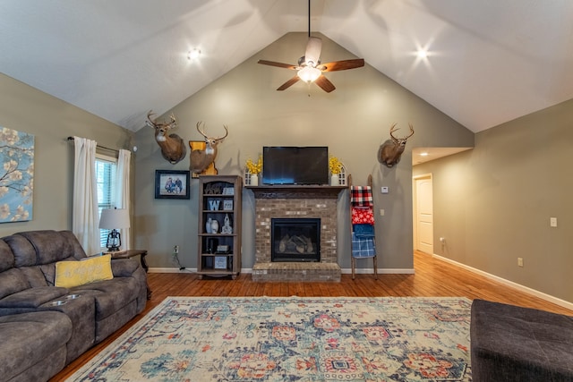 living area with a fireplace, wood finished floors, and baseboards