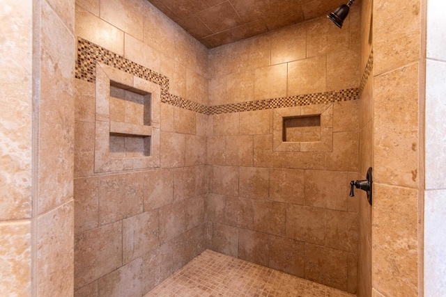 bathroom with tiled shower