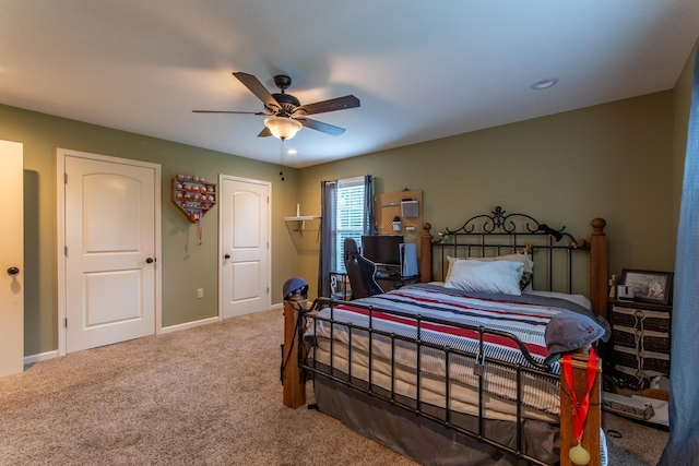 carpeted bedroom with a ceiling fan and baseboards