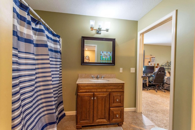 full bathroom featuring baseboards, a shower with curtain, tile patterned floors, a textured ceiling, and vanity