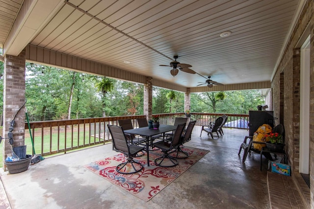 view of patio with outdoor dining space and a ceiling fan