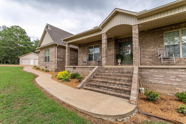 doorway to property featuring a garage, brick siding, a lawn, and a porch