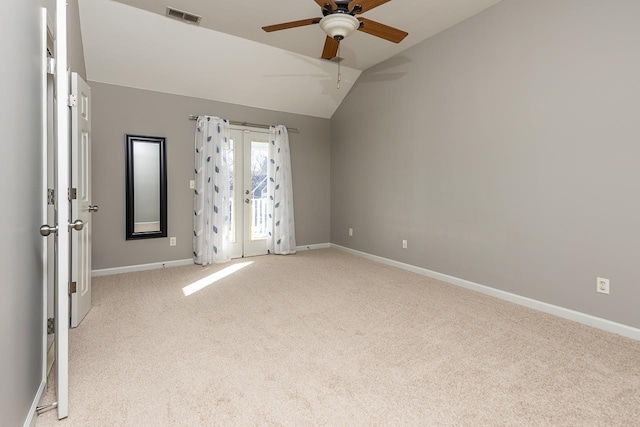 unfurnished room featuring french doors, lofted ceiling, light colored carpet, visible vents, and baseboards