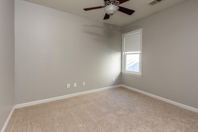 empty room with ceiling fan, carpet, and baseboards