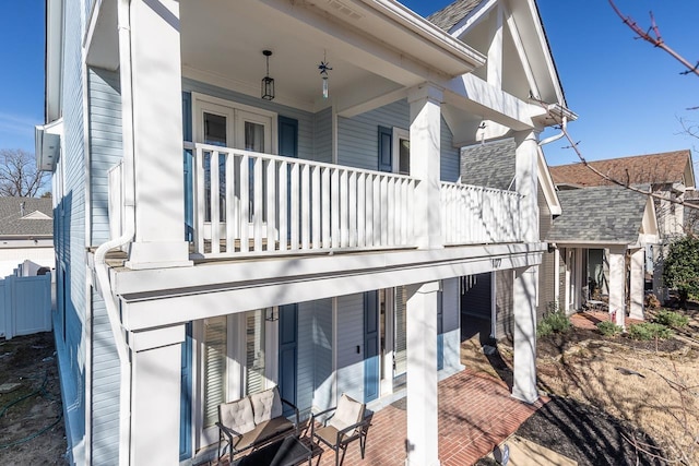 exterior space featuring covered porch and a balcony