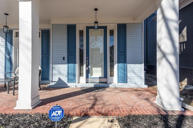 view of exterior entry with a porch