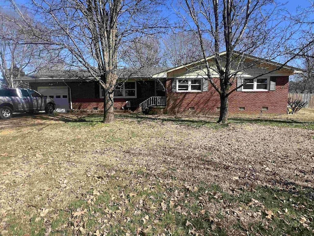 ranch-style home with crawl space, fence, and an attached garage