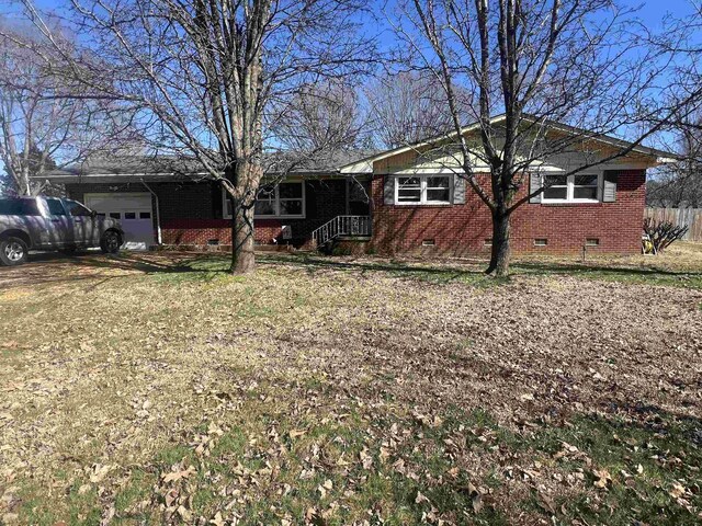 ranch-style house with fence, crawl space, a front lawn, and a garage