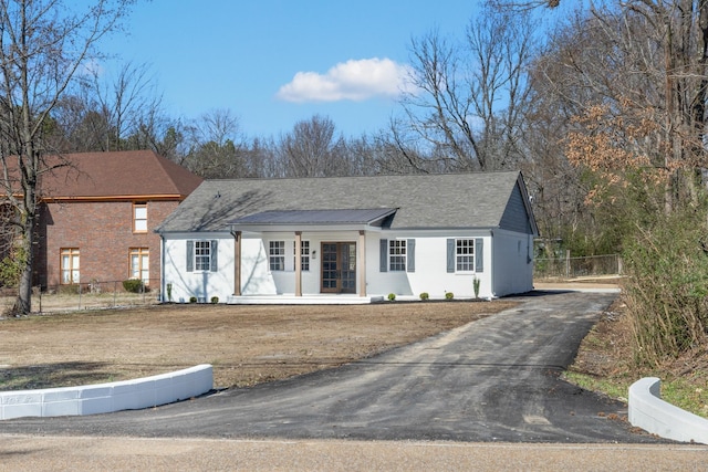 view of front of property with driveway and fence