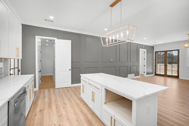 kitchen featuring dishwasher, pendant lighting, and light stone countertops