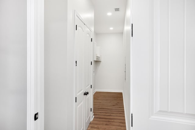 interior space featuring recessed lighting, dark wood-style flooring, visible vents, and baseboards