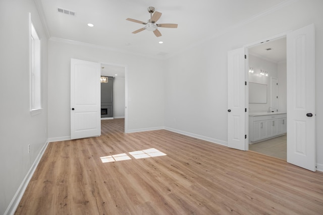 unfurnished bedroom with baseboards, visible vents, crown molding, and light wood finished floors