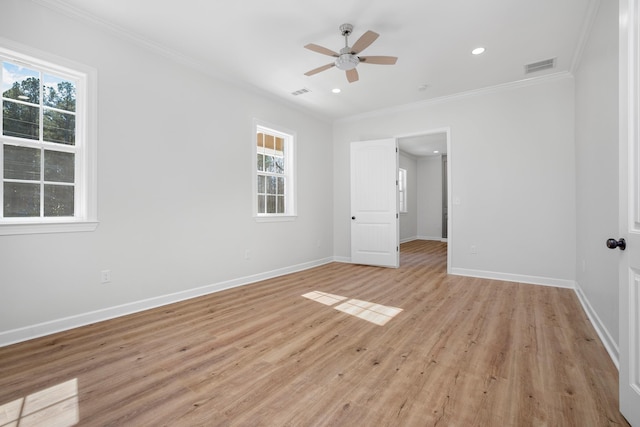 unfurnished bedroom featuring ornamental molding, light wood-type flooring, multiple windows, and baseboards