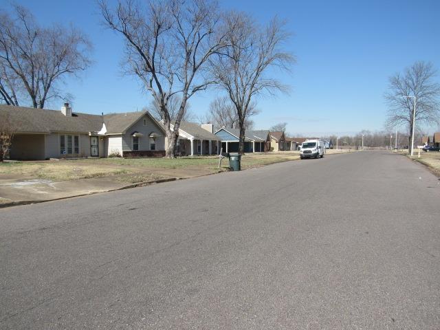 view of road featuring a residential view and curbs