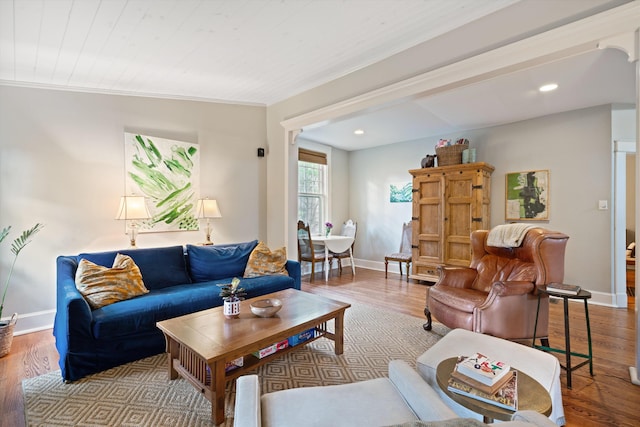 living room featuring baseboards, recessed lighting, and light wood-style floors