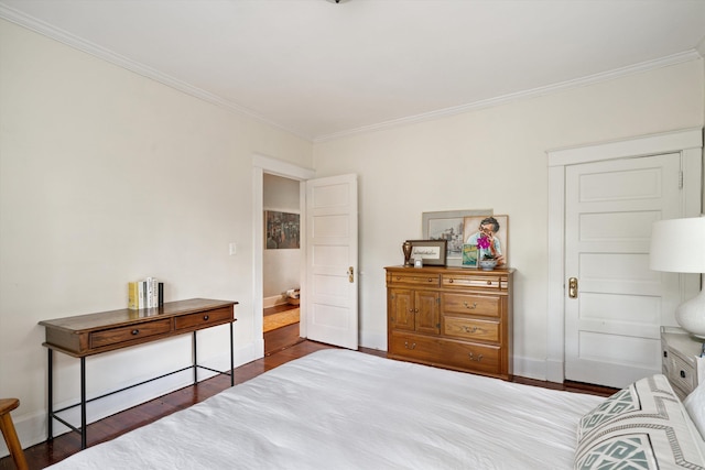 bedroom featuring crown molding, baseboards, and dark wood-style flooring