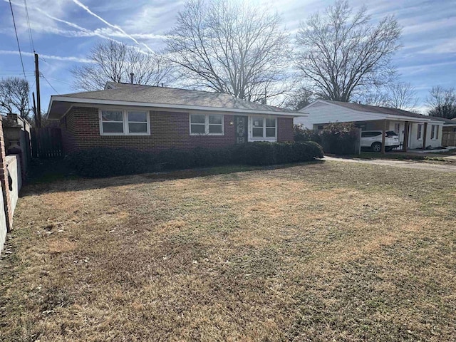 single story home with brick siding, fence, and a front lawn