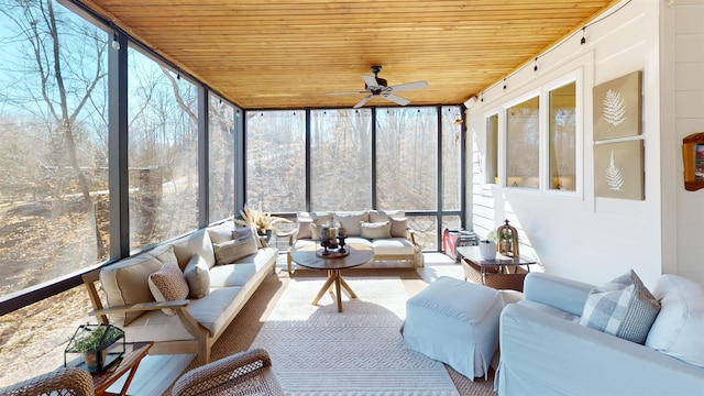 sunroom / solarium with a ceiling fan, a wealth of natural light, and wooden ceiling