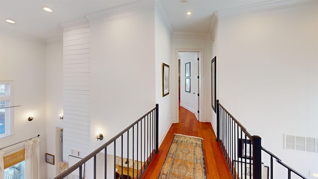 corridor featuring recessed lighting, an upstairs landing, visible vents, ornamental molding, and dark wood finished floors