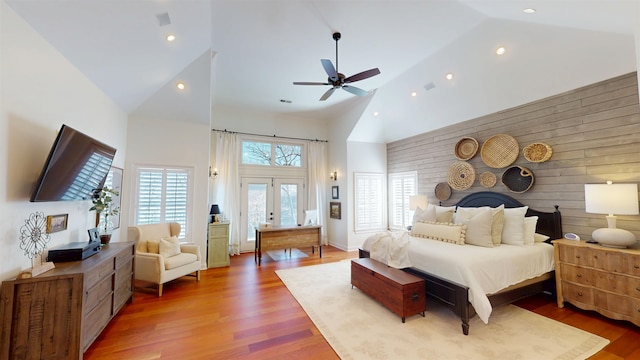 bedroom with high vaulted ceiling, french doors, wood finished floors, and access to outside