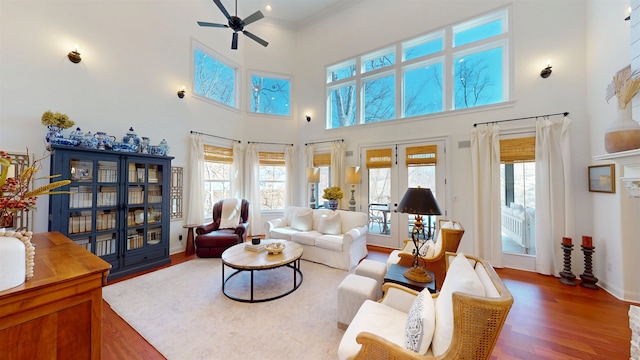 living area featuring dark wood-style floors, ceiling fan, french doors, and a wealth of natural light