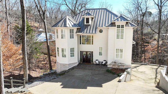 rear view of house featuring a standing seam roof and metal roof