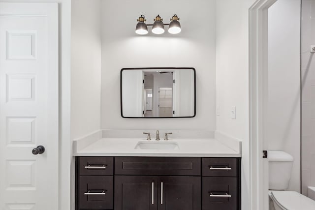 bathroom featuring vanity and toilet