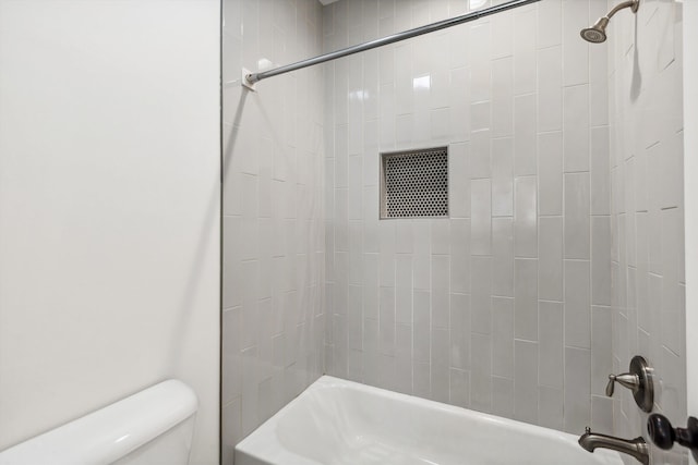 bathroom featuring toilet and washtub / shower combination