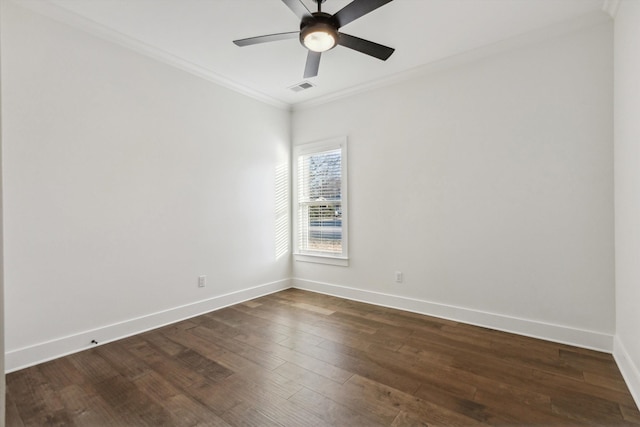 spare room featuring ornamental molding, visible vents, dark wood finished floors, and baseboards