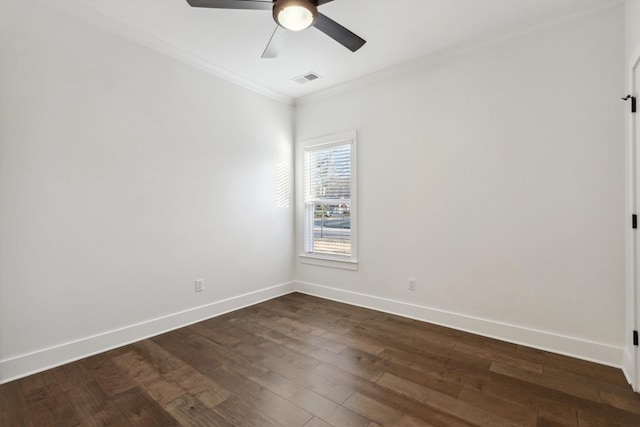 unfurnished room featuring crown molding, dark wood finished floors, visible vents, a ceiling fan, and baseboards