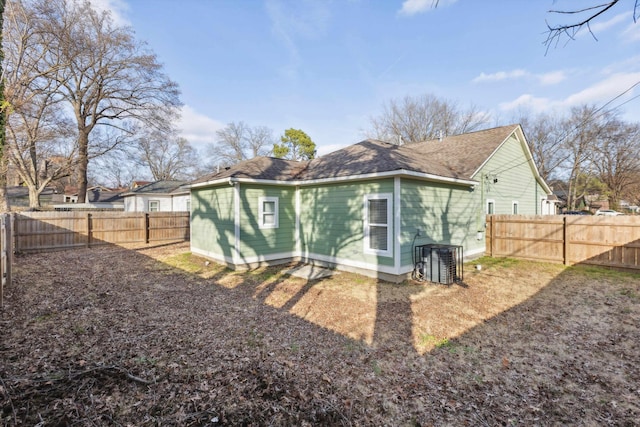 rear view of house with a fenced backyard