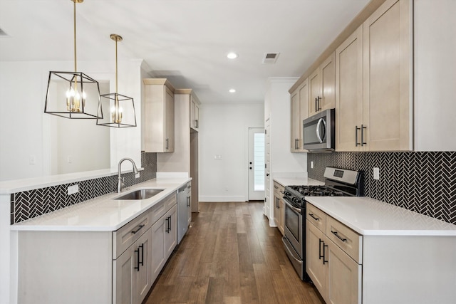 kitchen with pendant lighting, visible vents, decorative backsplash, appliances with stainless steel finishes, and a sink