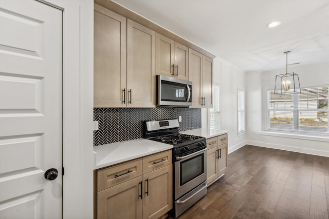 kitchen featuring stainless steel appliances, light countertops, backsplash, and light brown cabinets